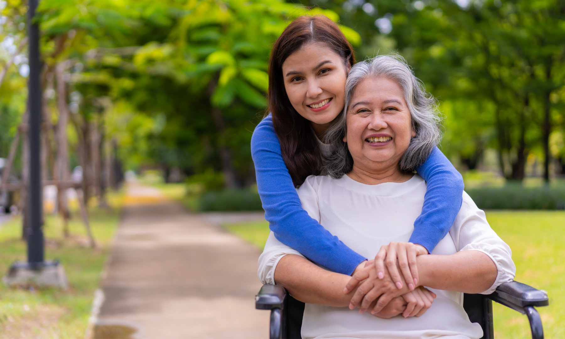 MND Queensland Carer Program image of a young female carer with someone in a wheelchair